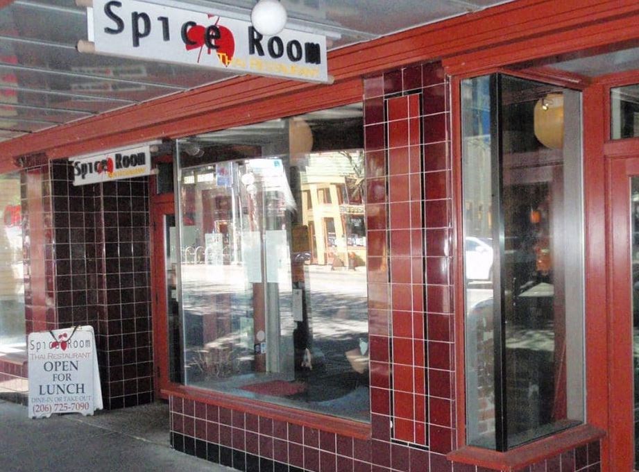the front of a restaurant with a sign in the window