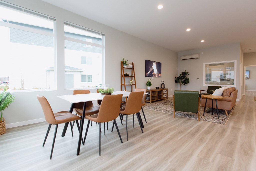 a dining room and living room with a table and chairs