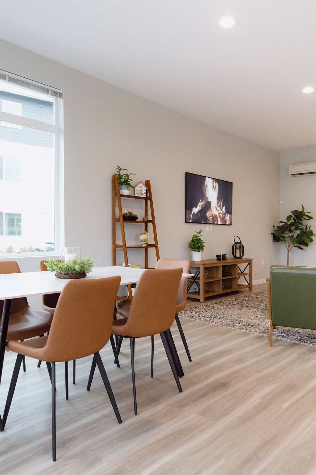 a dining room with a white table and chairs and a large window