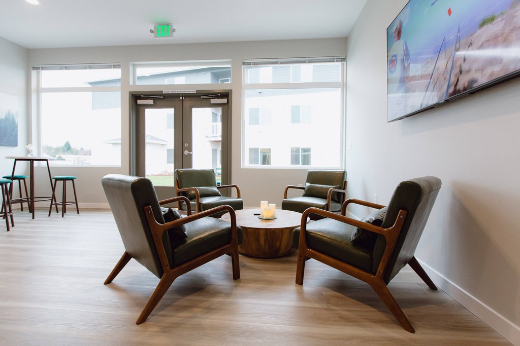 a living room with chairs and a coffee table