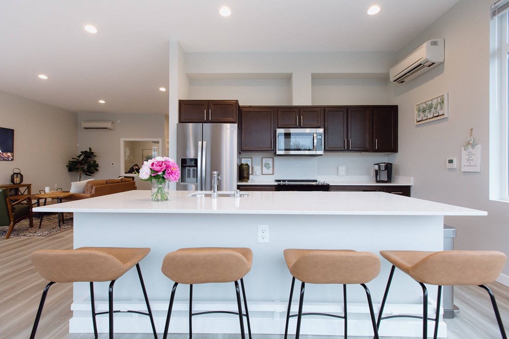 a kitchen with a large island with four stools