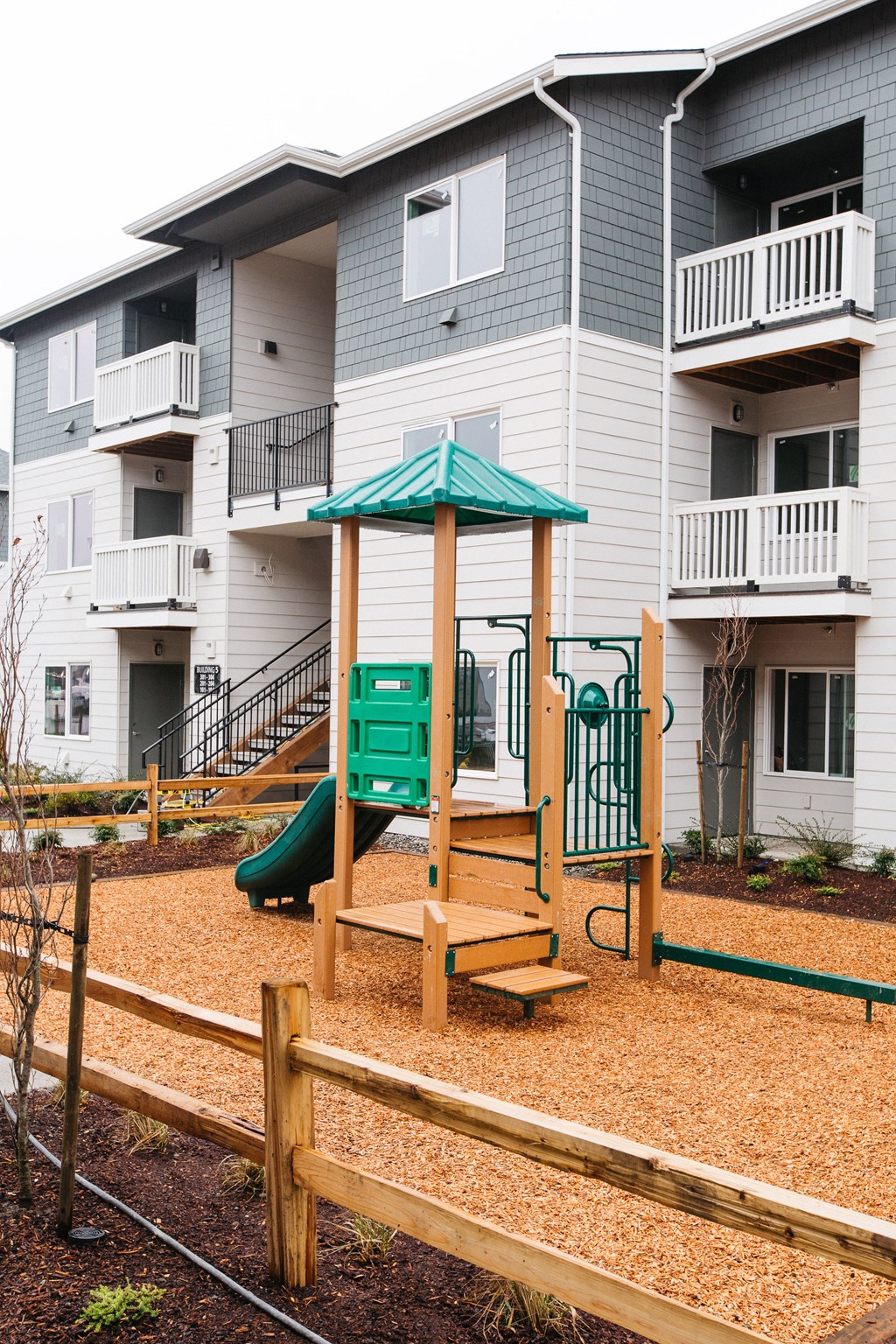 an empty playground in front of an apartment building