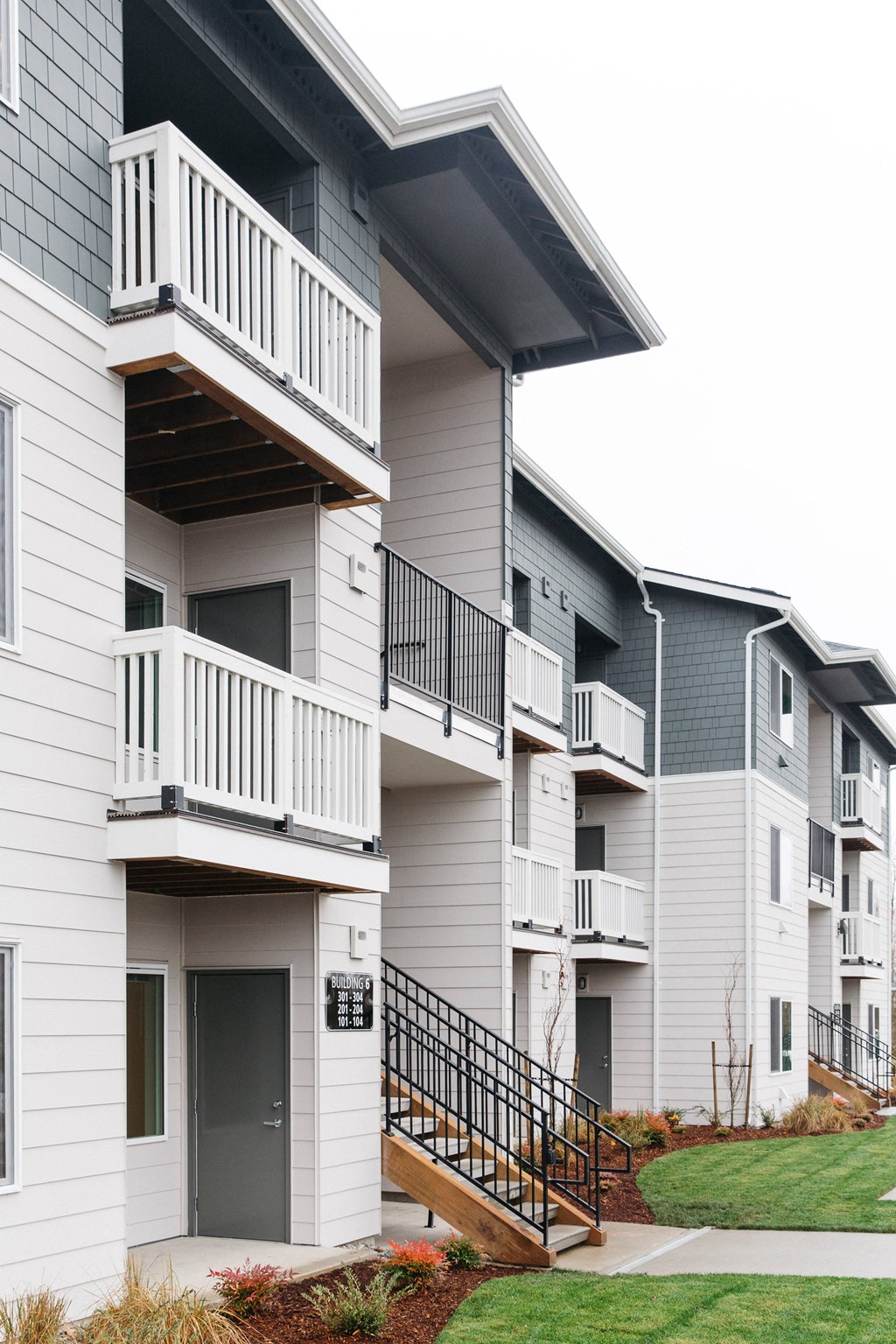 a row of townhomes with balconies and stairs