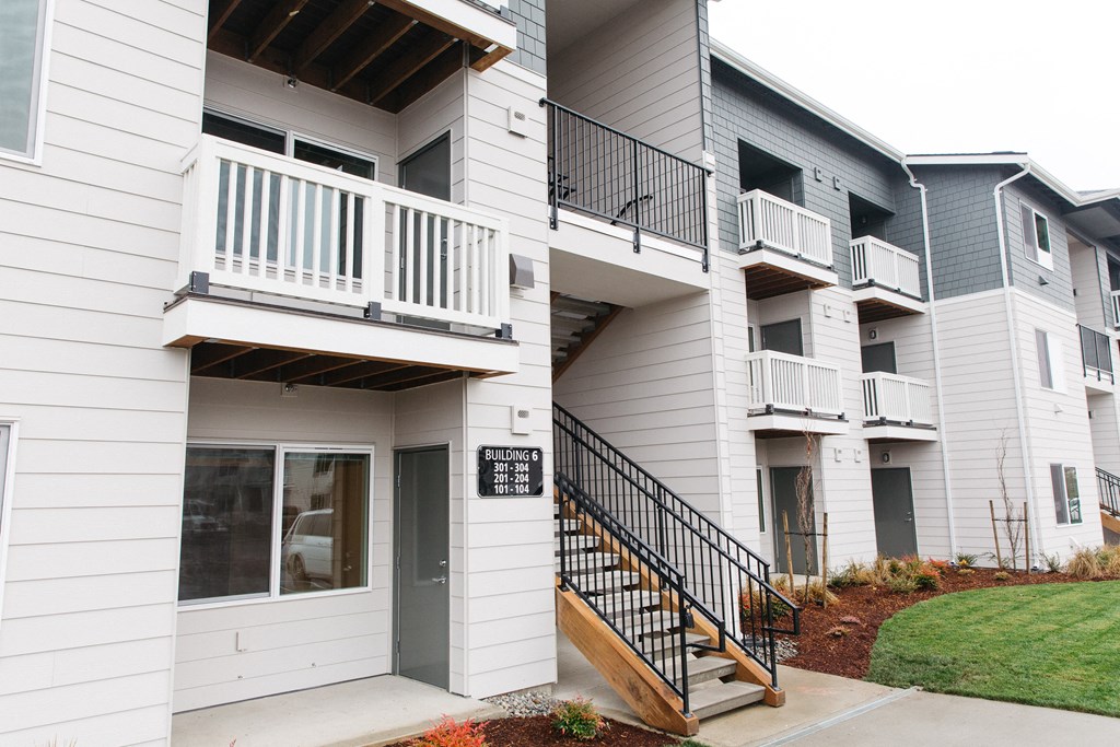 a view of the outside of a building with stairs and a sign