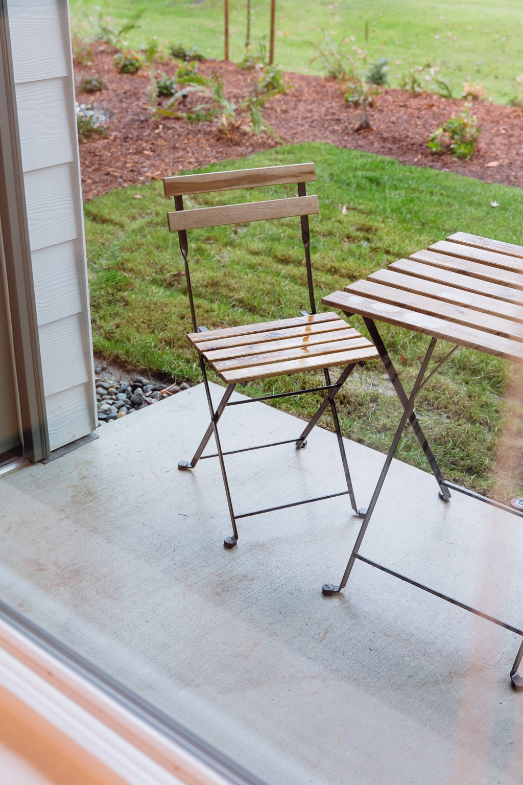 two wooden folding chairs sitting on a porch