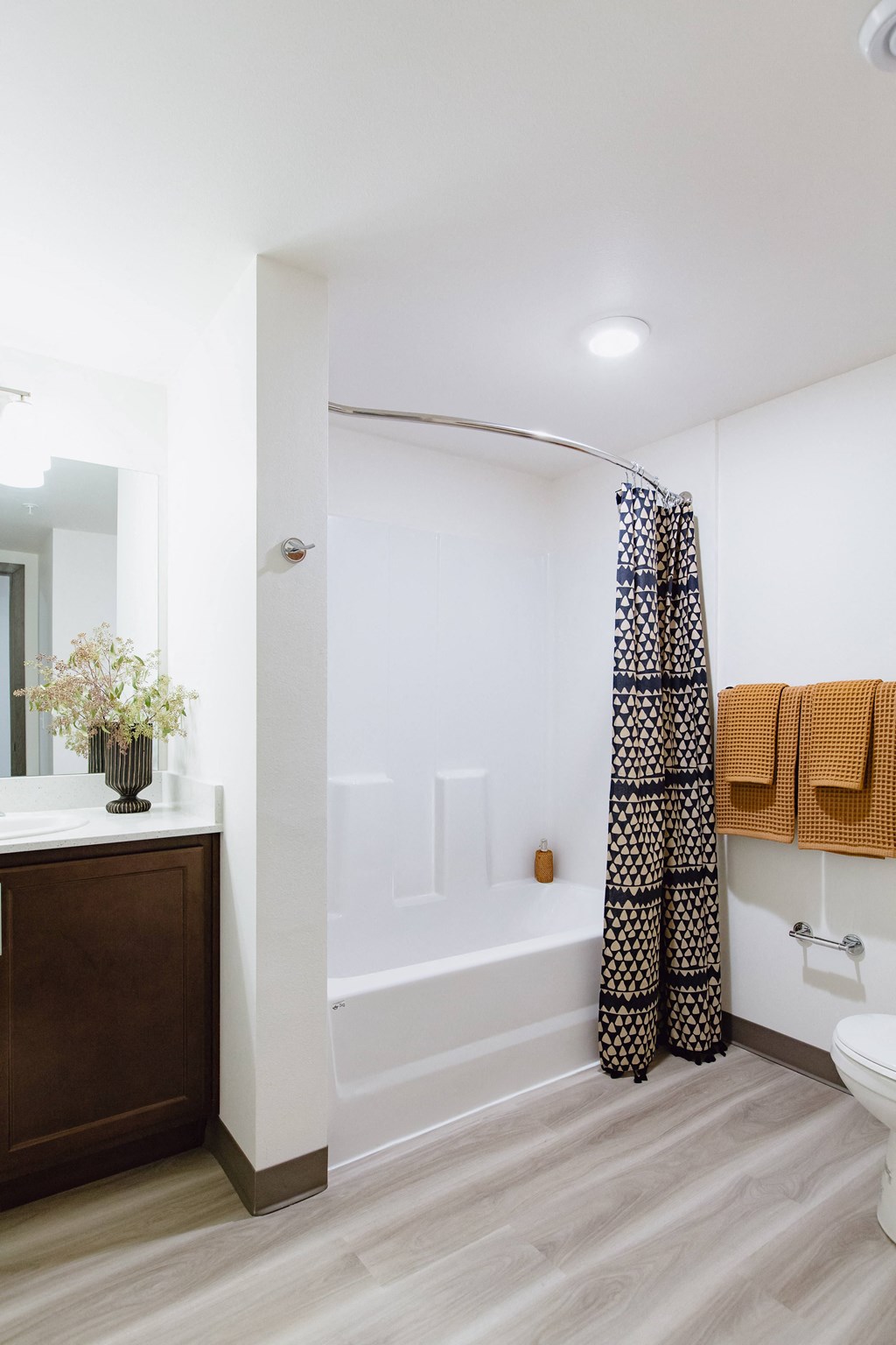a bathroom with a shower and a sink and a toilet