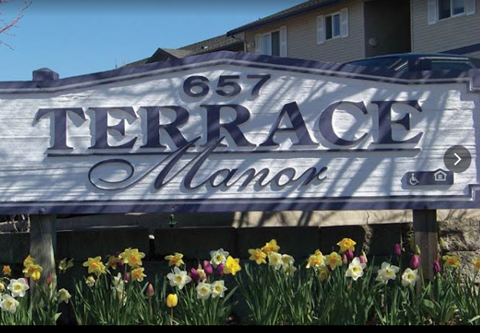 a sign that says terrace olamo in front of a house