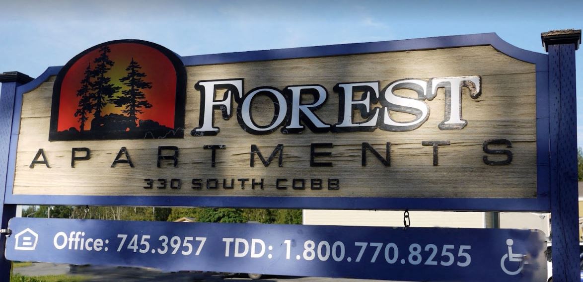 a sign for forest apartments is shown