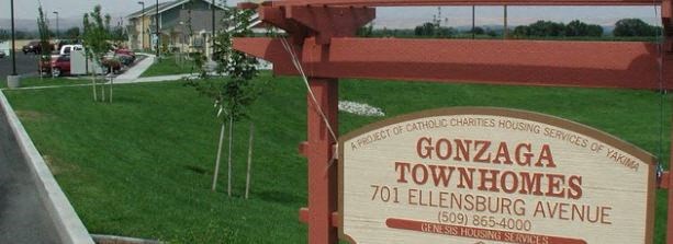 a sign for govada townhouses on the side of a road