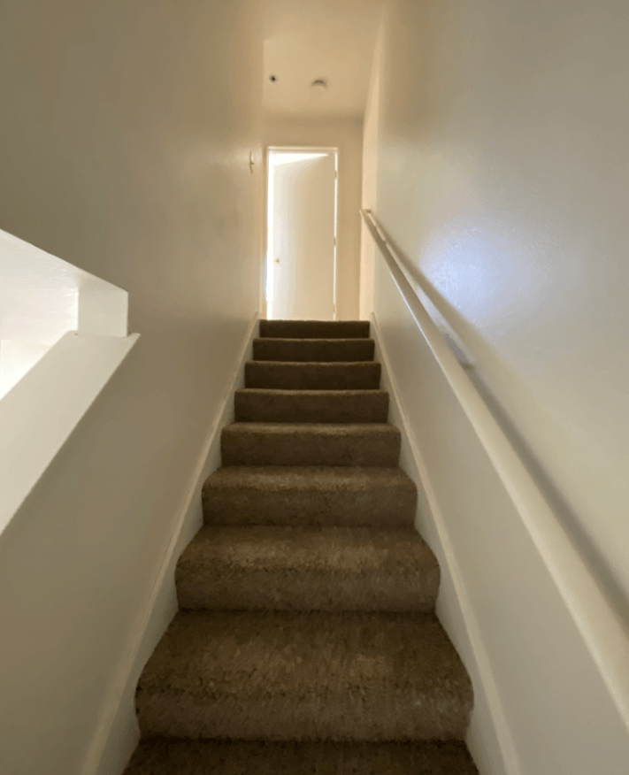 the stairway up to the second floor of a house