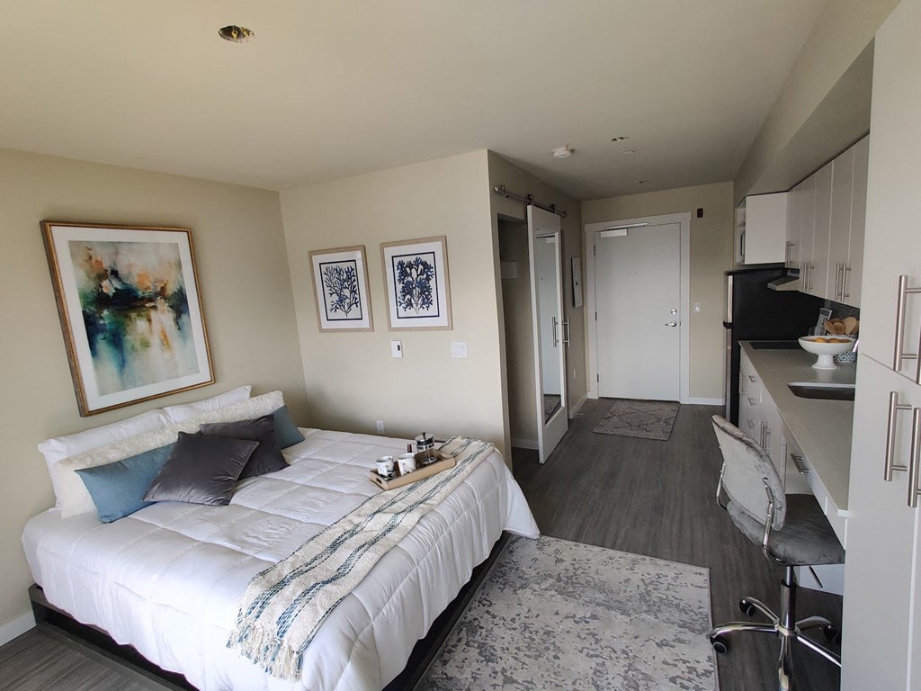 a bedroom with a bed and a living room