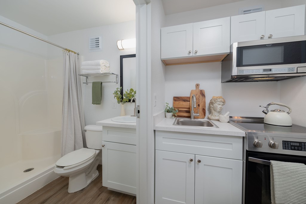 A white bathroom with a toilet, sink, and bathtub.