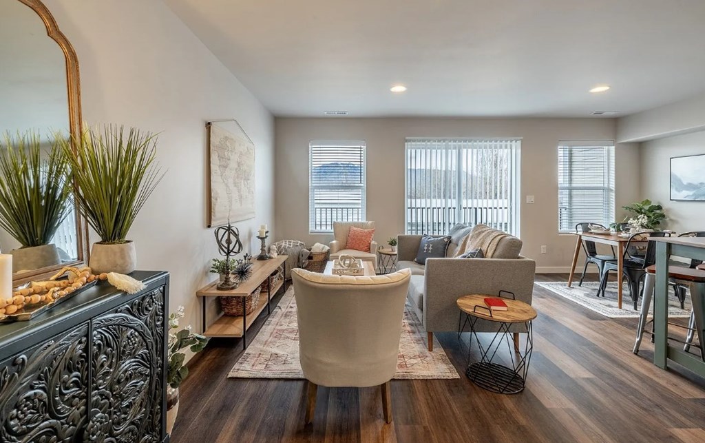 A living room with a large sofa and a wooden coffee table.