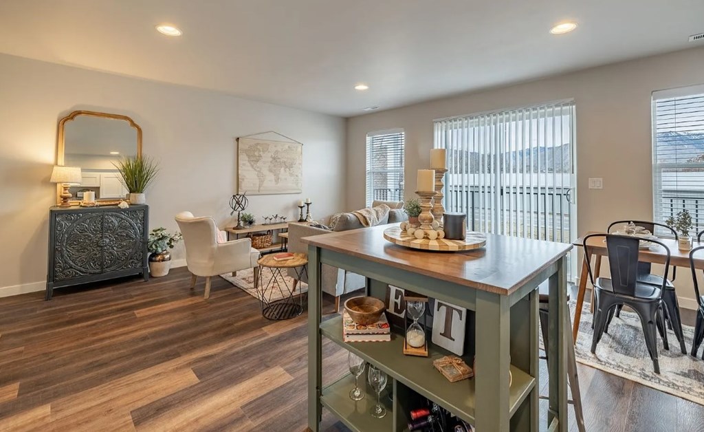 A dining room with a table set for a meal.