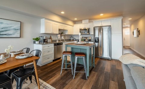 A modern kitchen with a dining table and chairs.