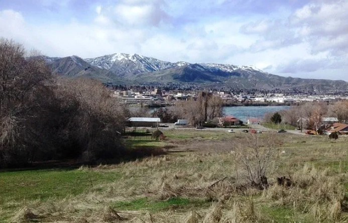 A landscape with a mountain in the background and a lake in the middle ground.