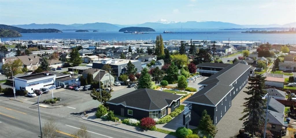 an aerial view of a small town with a lake in the background