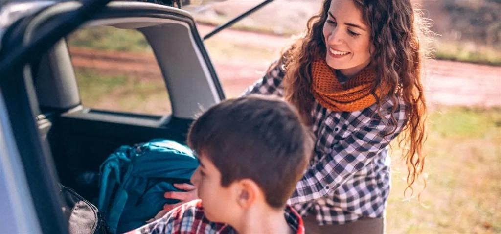 a woman and a boy in the back of a car