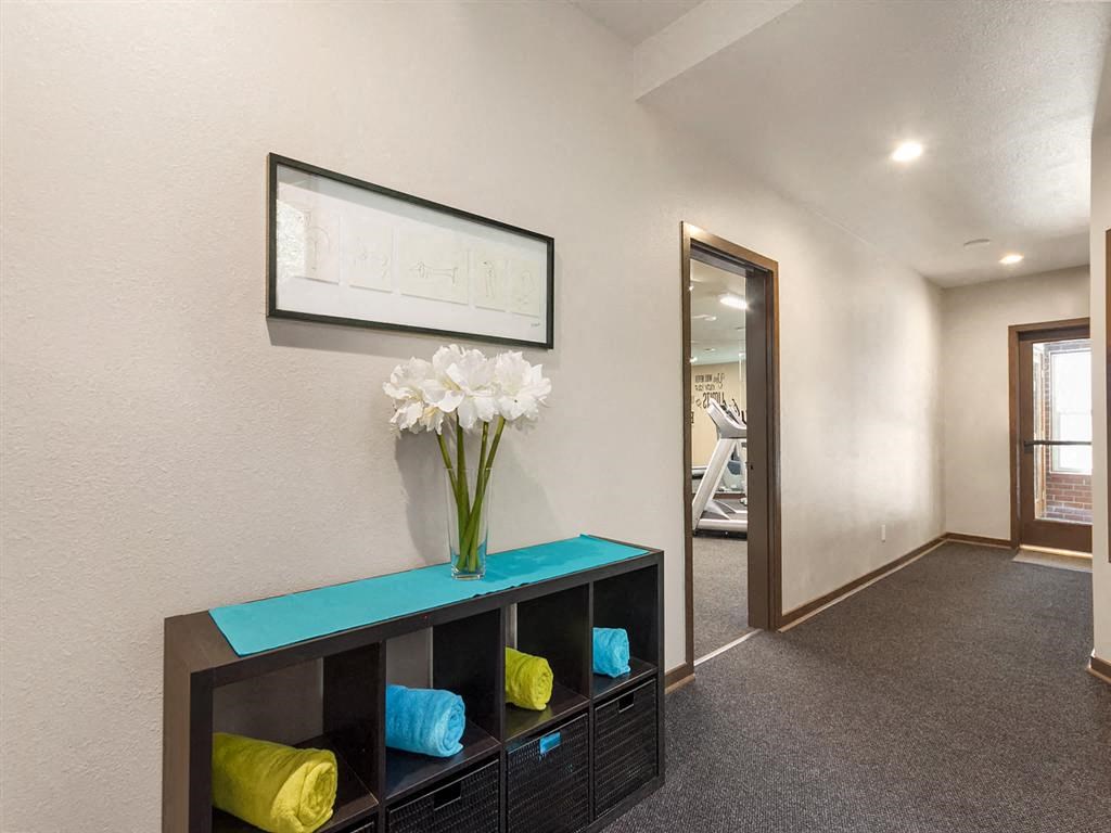 a living room with a vase of flowers on a shelf