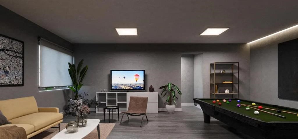 a living room with a pool table and a television