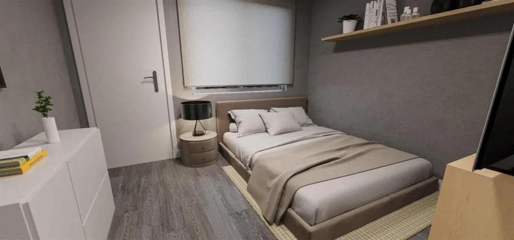 a small bedroom with a bed and a window