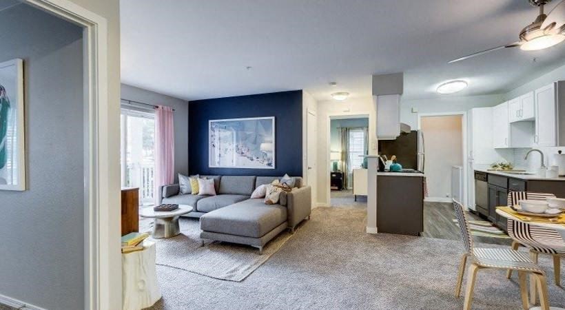 a living room with a couch and a kitchen