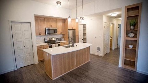 a large kitchen with a white counter top