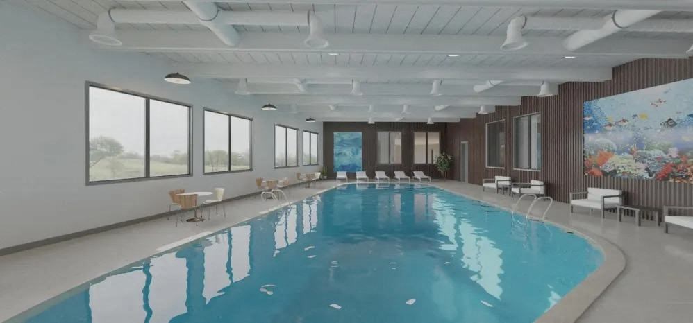 a swimming pool in a large room with chairs and a large window