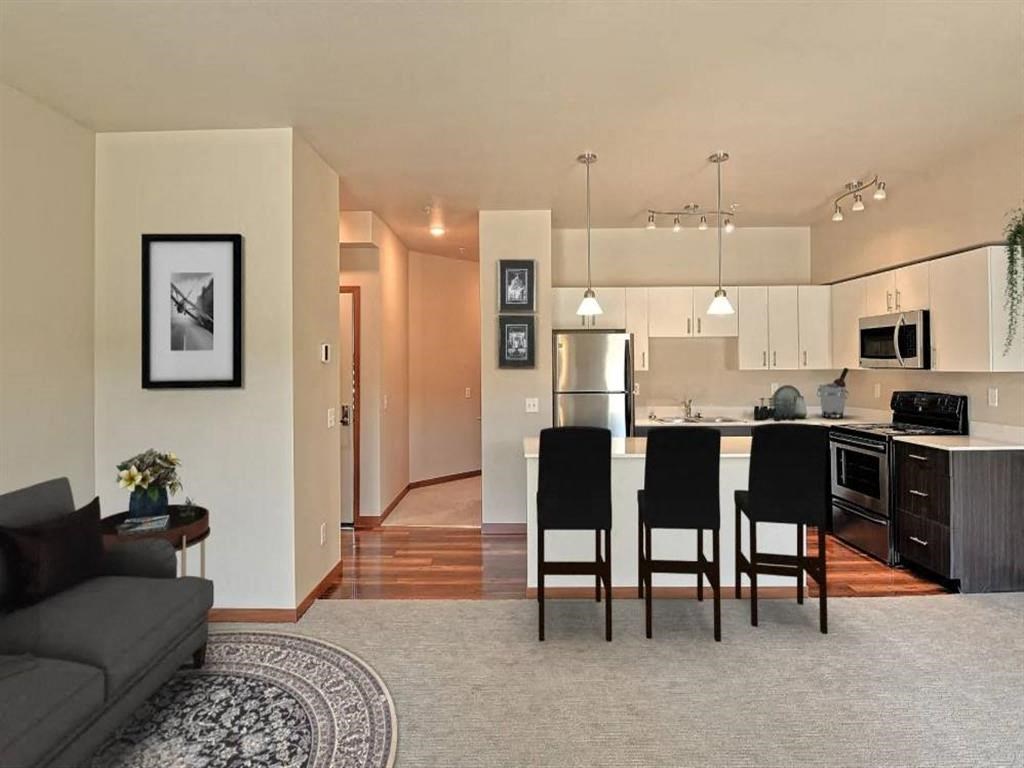 an open kitchen and living room with a table and chairs