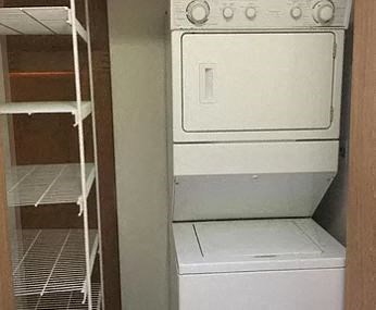 an empty closet with a stove and a refrigerator
