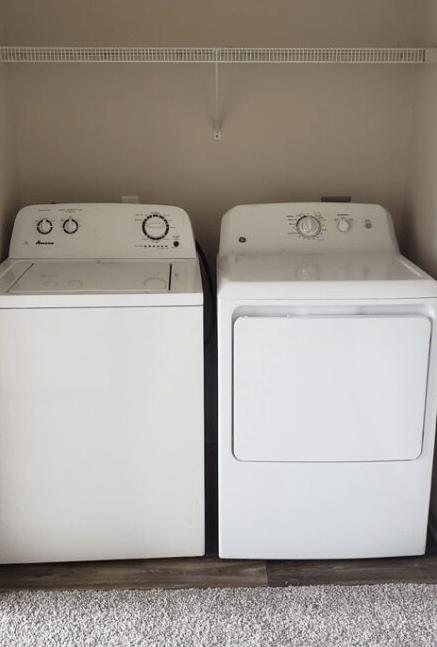 two white washing machines sitting next to each other
