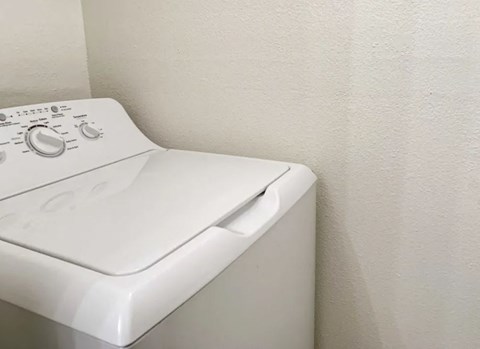 a white washer and dryer in a white room