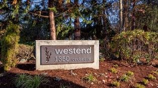 a sign for westend in front of some trees