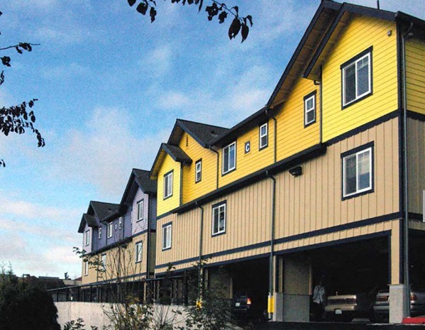 A yellow and brown building with a blue sky in the background.