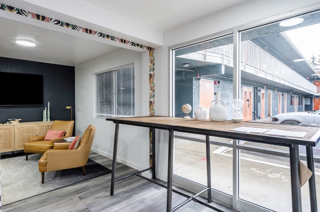 A modern living room with a yellow chair and a wooden table.