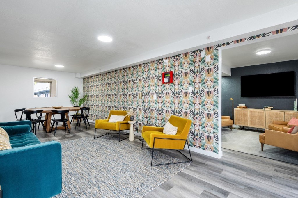 A room with a patterned wallpaper and a red square on it.
