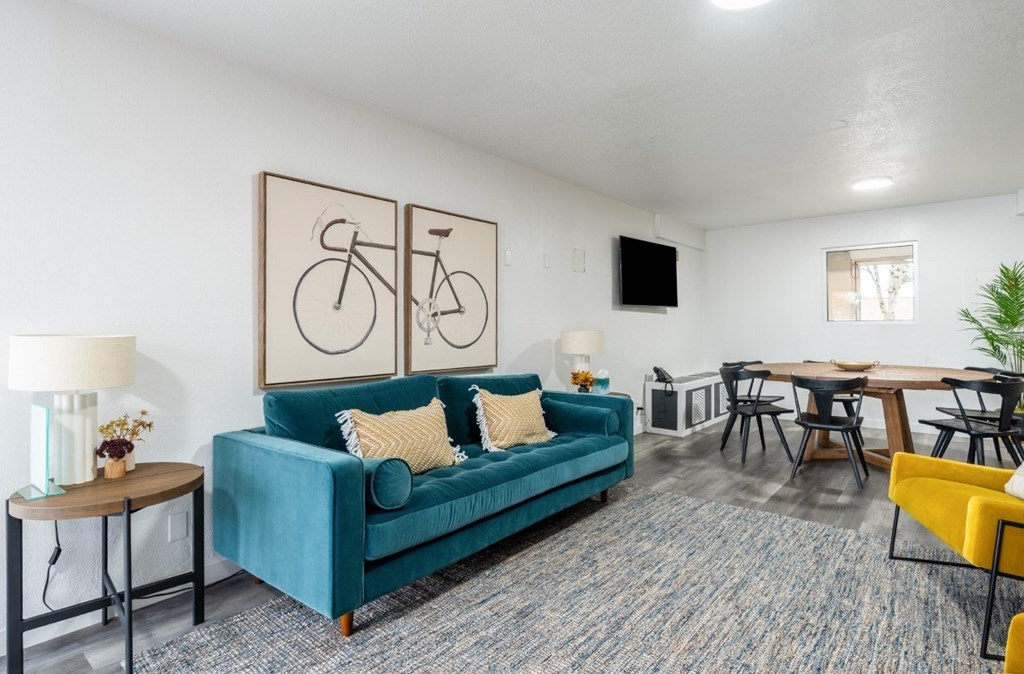 A living room with a blue couch and a television.