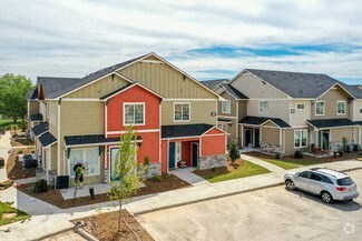 a row of houses with a car parked in a parking lot