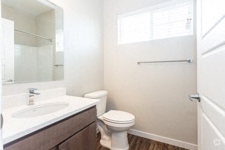 a bathroom with a toilet and a sink and a mirror