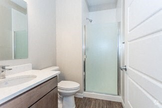 a bathroom with a toilet sink and a shower