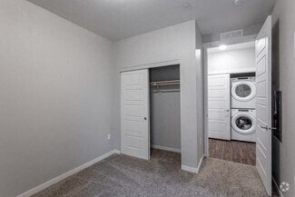 a white room with a laundry room and a white door