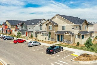a parking lot in front of a row of houses