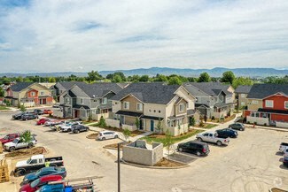 an aerial view of a neighborhood with cars parked in a parking lot