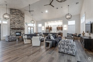 a large living room with couches and chairs and a fireplace