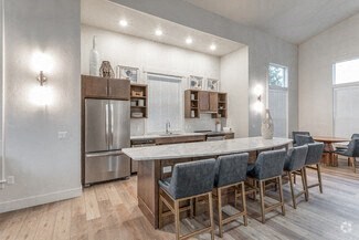 a large kitchen with a large island and chairs