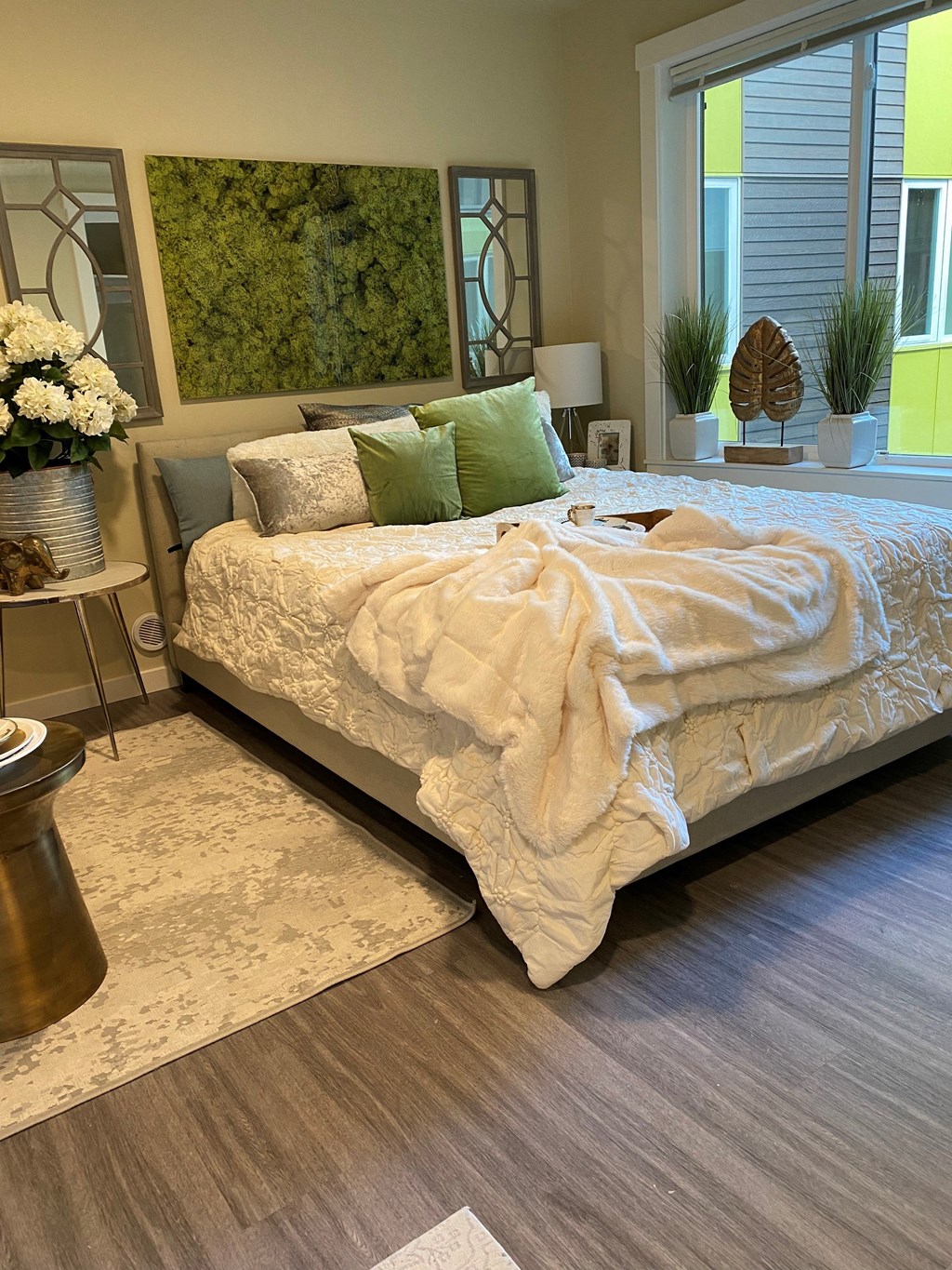 a bedroom with a bed and a rug and a window