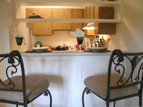 a kitchen with two chairs and a counter
