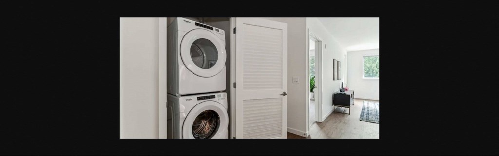 a white washer and dryer in a white laundry room