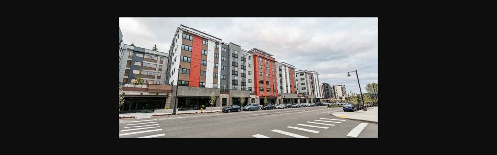 a view of a city street with tall buildings