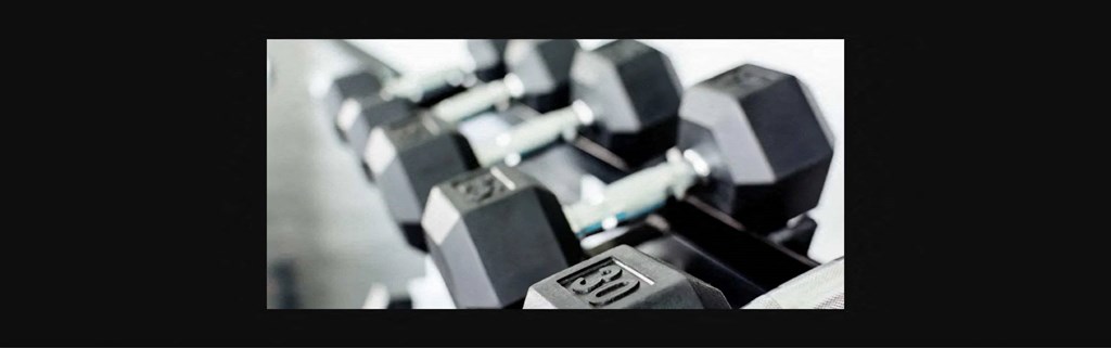 a pile of weights on a black background
